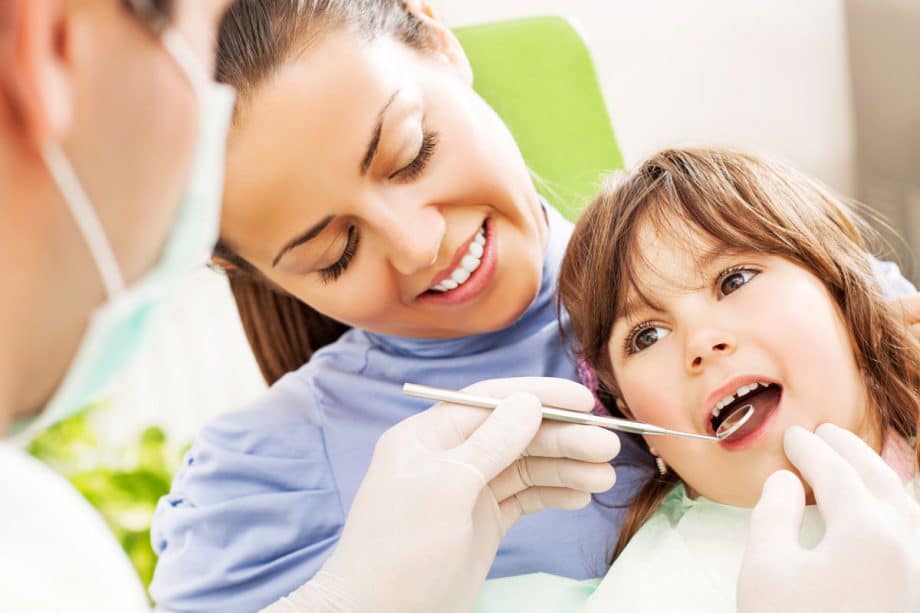 mother with child in dental chair